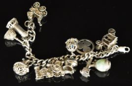 A silver charm bracelet with twelve charms including shamrock pendant/ charm, carts, etc, 102g