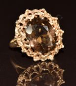 A 9ct gold ring set with an oval smoky quartz, 3.5g, size M
