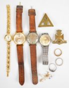 Three silver rings including one set with emeralds, two pairs of 9ct gold earrings, two military