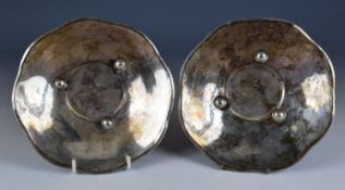Pair of Persian, Iranian or similar silver dishes with engraved decoration, raised on three ball
