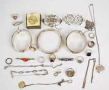 A collection of silver jewellery including two bangles, flapper bangle, seven rings, five