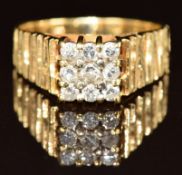 An 18ct gold ring set with nine diamonds in a square setting, 5.3g, size N