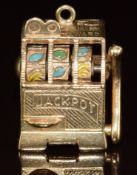 A 9ct gold charm in the form of a fruit machine, with working lever and wheels, 16.7g, 2.5cm
