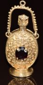 A 9ct gold charm / pendant in the form of a perfume bottle, set with garnets, 14.1g, 4.5cm