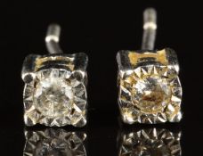 A pair of 9ct white gold earrings each set with a diamond, 0.8g