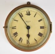 Smiths Astral ship's bulkhead clock in brass case mounted on a wooden board, diameter of clock 18.