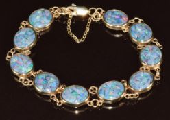 A 9ct gold bracelet set with opal mosaic panels, 11.2g, 18cm