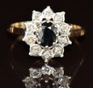A 9ct gold ring set with an oval cut sapphire surrounded by diamonds, 3.2g, size Q