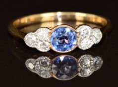 An 18ct gold ring set with a round cut sapphire of approximately 0.35ct and six diamonds, 1.9g, size