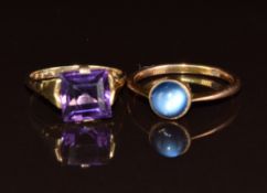 A 9ct gold ring set with an amethyst and a 9ct gold ring set with a glass cabochon, 5.1g, sizes