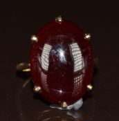 A 9ct gold ring set with a garnet cabochon, 5.6g, size O