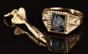 A 9ct gold ring set with a hematite intaglio and a 9ct gold charm in the form of a dart, 4g, size I