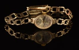 H Samuel 9ct gold ladies wristwatch with blued hands, gold baton hour markers, silver dial and