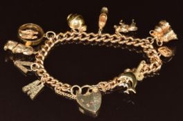 A 9ct gold charm bracelet with eleven 9ct gold charms including bells, rabbit, four initials 'R', '