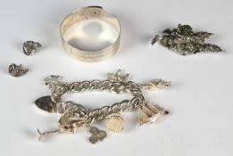 A hallmarked silver bangle by Charles Horner (Chester 1945), silver charm bracelet with eight silver