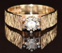 A 9ct gold ring set with a synthetic stone, with bark effect band, 4.3g, size O