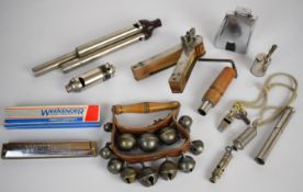 Collection of musical instruments, stage sound effects and whistles, including Bakelite three branch