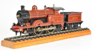 Bassett-Lowke 0 gauge live steam 0-4-0 tender locomotive, on display track, together with six