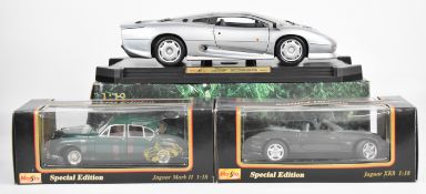 Three Maisto 1:12 and 1:18 diecast model Jaguars comprising XK8 31836, Mark II (1959) 31833 and
