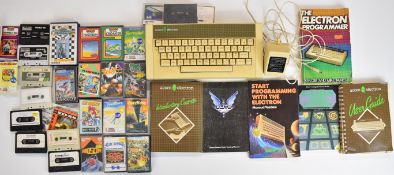 Acorn Electron retro home computer system with programming manuals and a collection of games.