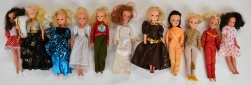 Eleven vintage Pedigree Sindy dolls wearing 1970'/80's outfits.