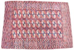 Bokhara rug with thirty guls and geometric borders on a wine ground, 127 x 177cm