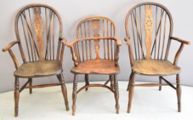 Three 19thC elm seated Windsor armchairs including a pair with shaped arms and pierced central
