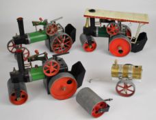 Three Mamod TE1A and SR1A live steam traction engines and rollers, including a spare set of front