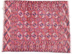 A 19th/20thC Turkoman rug with eighteen guls on a wine ground, 135 x 106cm