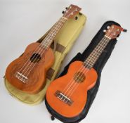 Two concert ukuleles comprising Flight NUS350DC and Brunswick BU1S, both in soft carry cases.