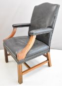 19thC leather / faux leather upholstered mahogany armchair with padded arm rests, height 100cm