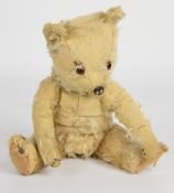 A vintage Teddy bear with golden mohair, disc joints, cloth pads and stitched features, height 30cm