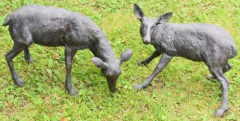 Two bronze ornamental garden deer, largest 70cm long.