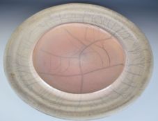 John Dunn (b1944) large studio pottery charger with speckled pink iridescent raku glaze, signed