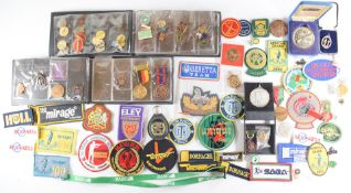 A collection of gun and shooting related badges, patches and medals including Gloucestershire