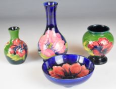 Three Moorcroft vases and a pedestal dish decorated in Hibiscus, Anemone and Magnolia patterns