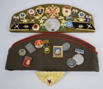 Collection of Russian and Eastern Bloc hats including eight side hats, cold weather hat, felt cap