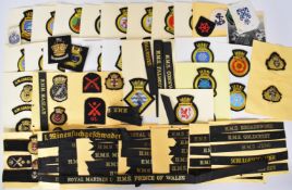 Approximately one hundred and fifty Royal Navy cloth and bullion cap badges and tallies including