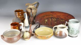 Collection of studio pottery including a large charger with indistinct impressed mark, two
