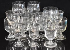 Fifteen Georgian / Victorian glass drinking glasses including rummers, some with hollow stems and