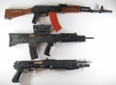 Three airsoft guns comprising two assault style rifles and one in the form of a tactical shotgun