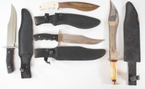 Three 'Bowie' style hunting knives together with a kukri style knife, all with sheaths, longest