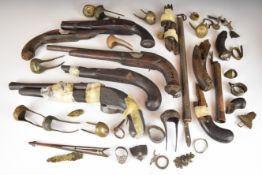 A collection of flintlock and percussion pistols and pistol parts including barrels, engraved
