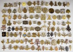 Approximately one hundred British, Canadian, Scottish cap badges including East Lancashire Regiment,
