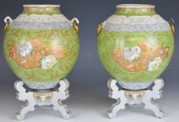 Pair of 19thC vases on stands with Chinese enamelled and relief moulded decoration, height on stands