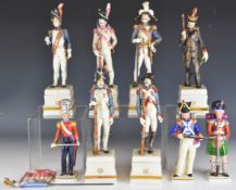 Capodimonte / Naples / Sitzendorf nine porcelain figures of 19thC soldiers including 11th Highland