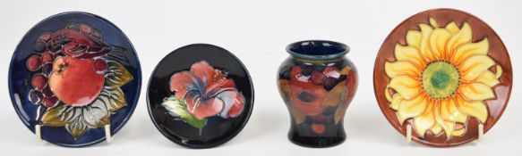 Moorcroft vase and three pin dishes decorated in the Pomegranate, Sunflower, Clematis and Finches