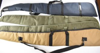 Four various padded shotgun or rifle slips including one Elderkin & Son Gunmakers, Spalding.