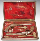 A cased pair of target or duelling pistols, each with engraved lock, hammer spurred trigger guard