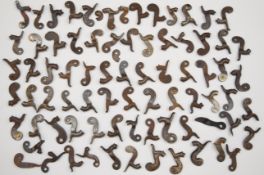 Over 70 percussion gun hammers of various sizes, some in the form of stylised dolphins and many with